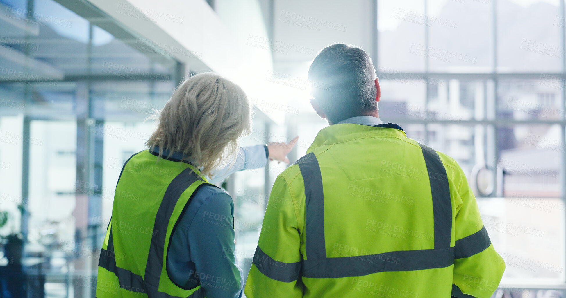 Buy stock photo Back, people and engineering with discussion at construction site, building inspection and teamwork. Architecture, civil engineer collaboration and man with woman pointing for real estate development