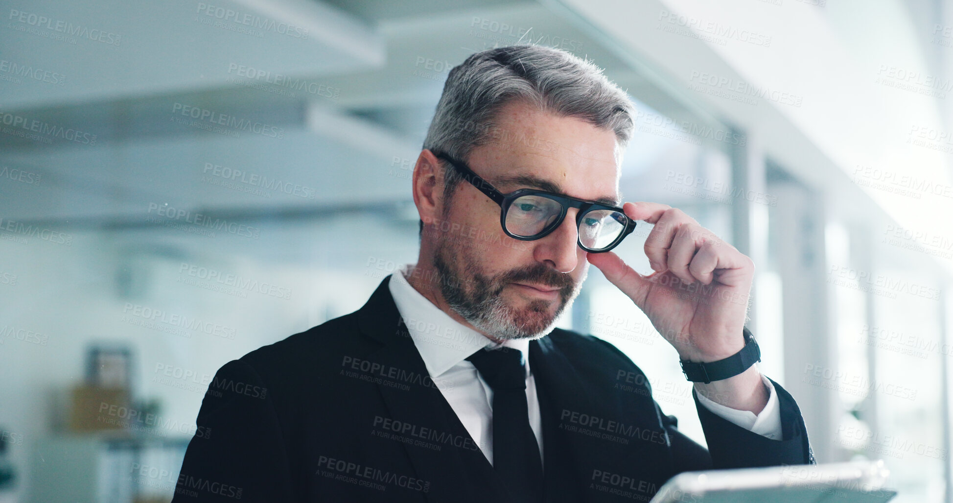 Buy stock photo Glasses, mature or businessman in office with tablet, reading email or review of finance report. Corporate, research or person in company with technology, planning or evaluation for financial audit