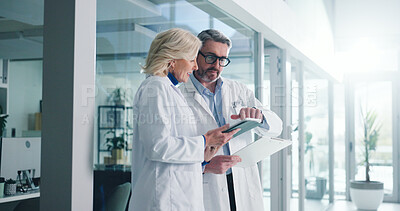 Buy stock photo Teamwork, tablet and planning with doctors in hospital for healthcare report, research and reading. Medical case review, clinical guidelines and telehealth app with mature people for diagnosis