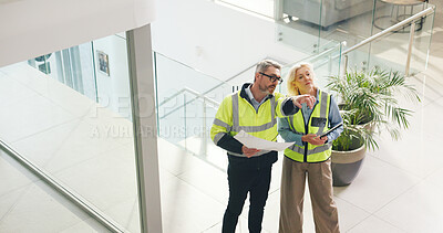Buy stock photo Architect, pointing and people with blueprint in office, talk and planning for property development. Civil engineer, mature woman and man with document for architecture, above and chat for renovation