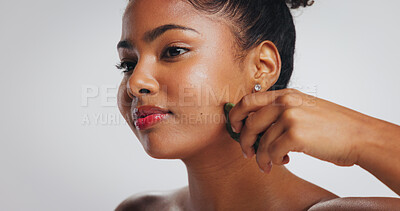 Buy stock photo Gua sha, skincare and African woman in studio for detox, lymphatic drainage and grooming. Spa, space and person with beauty tools for facial massage, anti aging and dermatology on white background