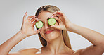 Cucumber, skincare and woman in studio, beauty and natural cosmetics on white background. Space, organic fruit and person with wellness, dermatology and detox with aesthetic, glow and diet benefits