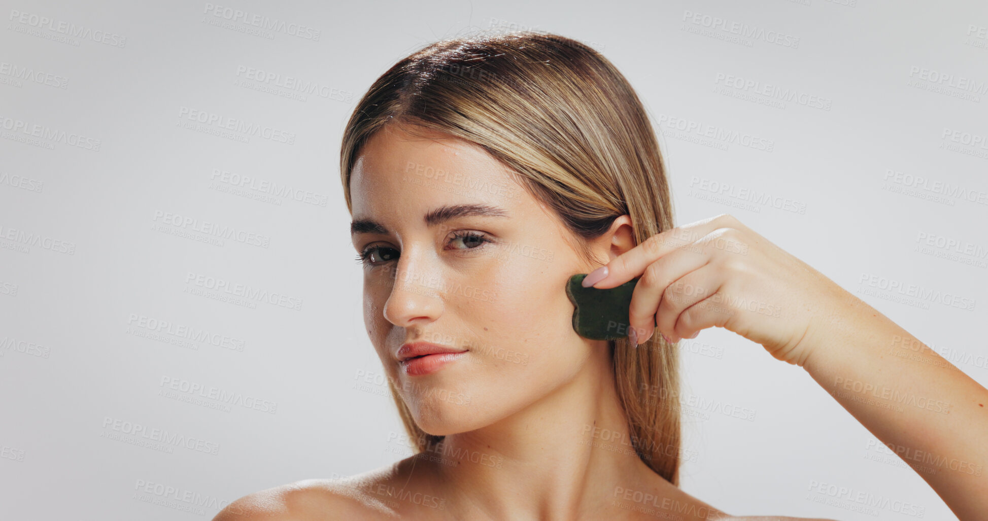 Buy stock photo Gua sha, skincare and portrait of woman in studio for detox, lymphatic drainage and grooming. Spa, space and person with beauty tools for facial massage, anti aging or dermatology on white background