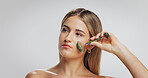 Beauty, jade roller and woman with thinking in studio for skin benefits, lymphatic drainage and glow. Mockup space, person and cosmetics tool on white background for anti aging or skincare reflection