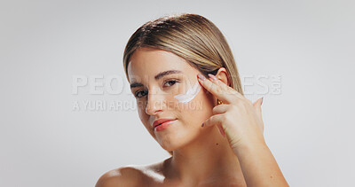 Buy stock photo Beauty, portrait and girl with face cream in studio for hydration, skin benefits or anti aging. Skincare, person and apply moisturizer on white background for radiant complexion, glow or mockup space