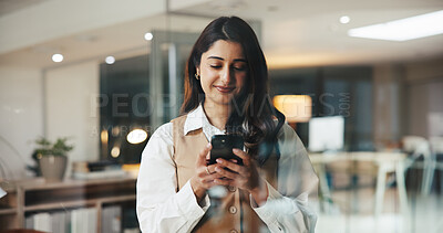 Buy stock photo Woman, phone and smile with texting at office, scroll and chat with contact for story lead at media agency. Person, writer or journalist on smartphone, happy and mobile app for networking at company
