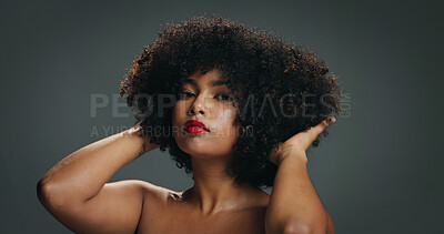 Buy stock photo Woman, natural hair and portrait with touch in studio for texture, haircare and cosmetics. Red lipstick, beauty and afro of African girl on gray background with shine, moisture and healthy growth