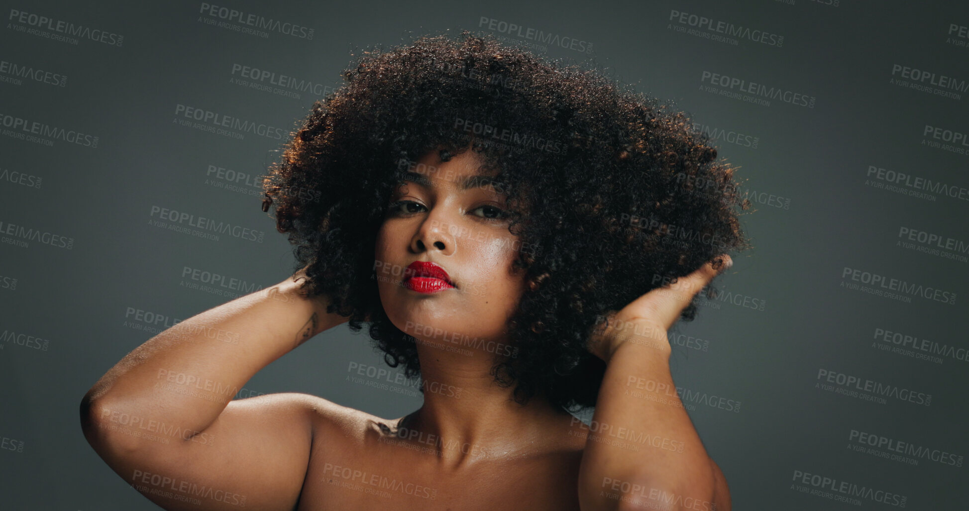 Buy stock photo Woman, natural hair and portrait with touch in studio for texture, haircare and cosmetics. Red lipstick, beauty and afro of African girl on gray background with shine, moisture and healthy growth