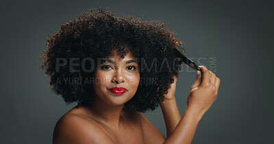 Buy stock photo African woman, natural hair and comb with portrait in studio for texture, haircare and cosmetics. Red lipstick, beauty and afro of happy girl on gray background with shine, moisture or healthy growth