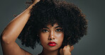 Portrait, face and woman in studio with afro, makeup and  organic cosmetic for healthy curls. Proud, confident and african female person with beauty, natural hair care and wellness on grey background