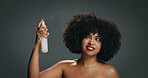 Woman, natural hair and spray in studio for texture, haircare and cosmetics. Red lipstick, beauty and african girl on gray background with afro shine, moisture mist and healthy growth product