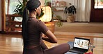 Back, meditation and online yoga class with black woman in home for awareness or holistic health. Balance, inner peace and laptop screen with person in apartment for video streaming of zen course