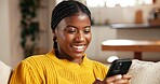 Black woman, phone and relax in home with social media, text message and reading online blog. Person, mobile and smile on living room sofa for funny email, meme website and chill with chat platform