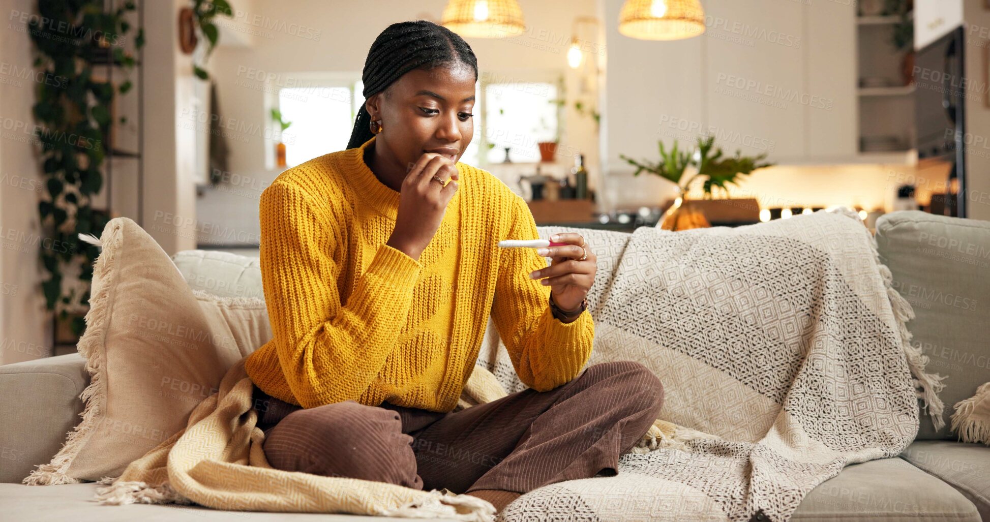 Buy stock photo Pregnancy test, surprise and black woman on sofa in home with fertility, ivf success and good news. Happy, relax and African female person with positive result on pregnant stick in living room.