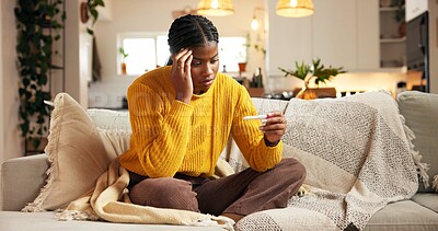 Buy stock photo Black woman, sofa or mistake with stress for pregnancy test, doubt or regret in home. Female person, worry or concern with unplanned fertility, anxiety or maternity stick for negative result in house