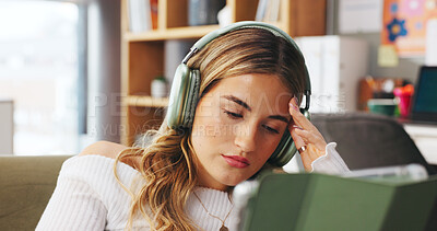 Buy stock photo Tired woman, headphones and listening with tablet in home for audio book, streaming or reading. Female person, user or technology with sound, fatigue or break for online app or ebook on sofa in house