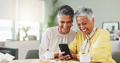 Buy stock photo Coffee, funny and phone with old women in living room of home for humor, comedy or visit. App, laughing and meme with senior friends at table together for bonding, joke or reaction to social media