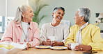 Women, meeting or gossip in home with tea, laughing or together for catch up session. Happy, female friends or conversation in kitchen with communication, discussion or bonding for connection.