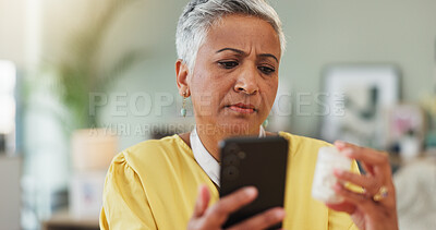 Buy stock photo Senior woman, phone and search with pills in home for side effects, benefits or label for decision. Person, smartphone and confused with drugs, app or pharmaceutical product for health in retirement