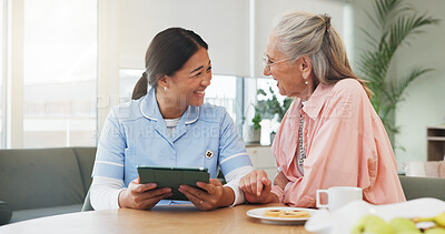Buy stock photo Tablet, nurse and senior woman in home for conversation, funny joke or check results at breakfast. Happy caregiver, elderly patient and tech for medical news, healthcare report or laugh in retirement
