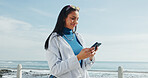 Smile, woman and phone on promenade for travel, social media and message contact on holiday. Female person, mobile app and texting, online chatting and fresh air for ocean vacation of getaway trip