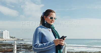 Buy stock photo Woman, reading and phone on promenade for travel, social media and message contact on holiday. Female person, mobile app and texting, online chatting and fresh air for ocean vacation of getaway trip