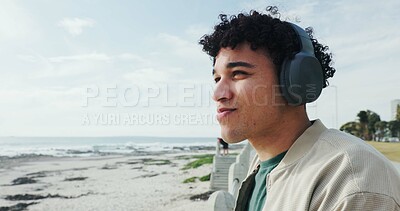 Buy stock photo Thinking, man and relax with headphones at beach for holiday ideas, vacation music or sightseeing. Sky space, person or listening to song on promenade for weekend trip, exploring nature or reflection