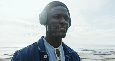 Buy stock photo Travel, man and thinking with headphones at ocean for holiday ideas, vacation album and reflection. Sky space, black person and listening to radio at beach for weekend trip, audio playlist or explore