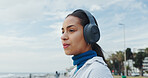 Thinking, beach and woman with headphones, breathing and calm with sound, holiday and zen. Ocean, wellness and healthy person with audio, podcast and listening to music, album playlist and reflection