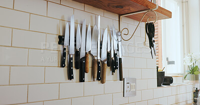 Buy stock photo Kitchen, wall and magnetic knife holder with cooking equipment for catering in small business. Steel blade, culinary tools and storage design of utensils, metal cutlery and arrangement in restaurant