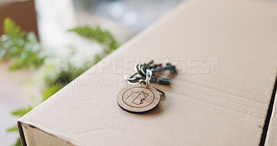 Buy stock photo Property, box and key in outdoor area, new home and investment in rental. Residential, mortgage and real estate on porch with cardboard container, capital assets and moving into starter apartment.