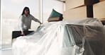 Sofa, cover and moving with woman in new home for property investment, renovation and future. Relocation, furniture and real estate rental with person in living room of apartment for packing