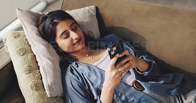 Buy stock photo Laying, text and woman in home with phone, rest and chat update in digital app. Relax, social media and freelancer in house with mobile, connection and screen time for virtual communication.