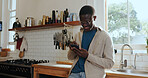 Phone, networking and black man in kitchen in home with communication, connectivity or chatting. Happy, technology and African male person with cellphone for social media on mobile app in apartment.