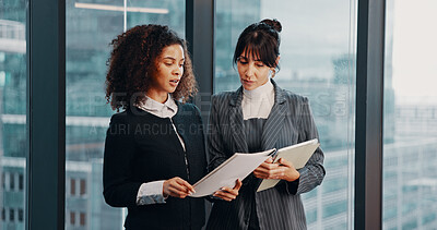Buy stock photo Meeting, documents and business women by window for financial review, discussion and feedback. Corporate, office and workers on tech with finance report for revenue,   proposal and budget planning