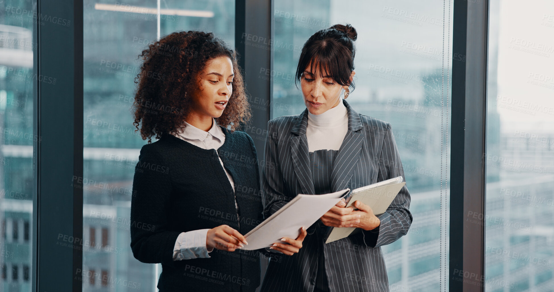 Buy stock photo Meeting, documents and business women by window for financial review, discussion and feedback. Corporate, office and workers on tech with finance report for revenue,   proposal and budget planning