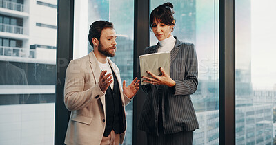 Buy stock photo Meeting, tablet and business people by window for financial review, discussion and feedback. Corporate, office and woman with man on tech with finance report for revenue, proposal and budget planning