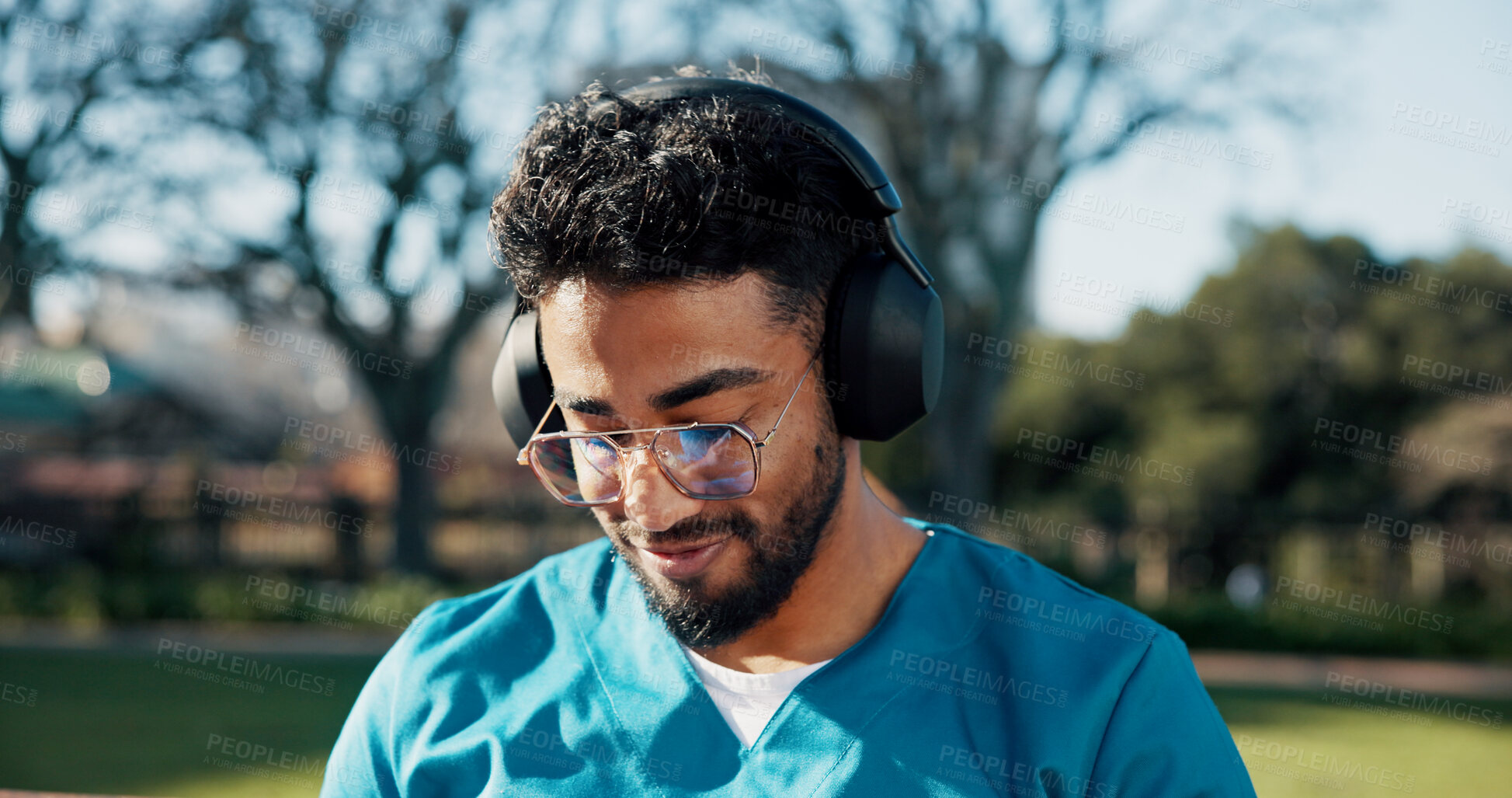 Buy stock photo Man, medical student and happy with headphones at park, streaming and listen to music on break at campus. Person, smile and audio with subscription, tech or album at healthcare college in Colombia
