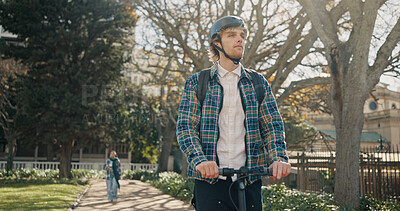 Buy stock photo Man, student and riding on scooter outdoor for travel, eco friendly and trip to college. Male person, search and helmet safety with electric transport, sustainable commute and journey to university