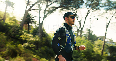 Buy stock photo Fitness, running or man with sunglasses in forest, marathon training or outdoor sport for health. Exercise, dedication or athlete in nature for workout, cardio or endurance practice for competition 
