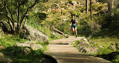 Buy stock photo Running, fitness and woman in forest, endurance and nature with path, wellness and cardio workout. Outdoor, healthy person and runner with exercise, practice and challenge with progress and energy