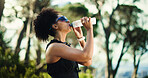 Thirsty, athlete or woman in nature with water, active or fitness in wellness for outdoor exercise. Training, cardio and African person with glasses, sportswear and hydration in park for body care.
