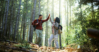 Buy stock photo Couple, high five and happy with hiking in forest with adventure, goal or achievement on travel. Man, woman and interracial relationship with celebration, love or success with backpack for trekking