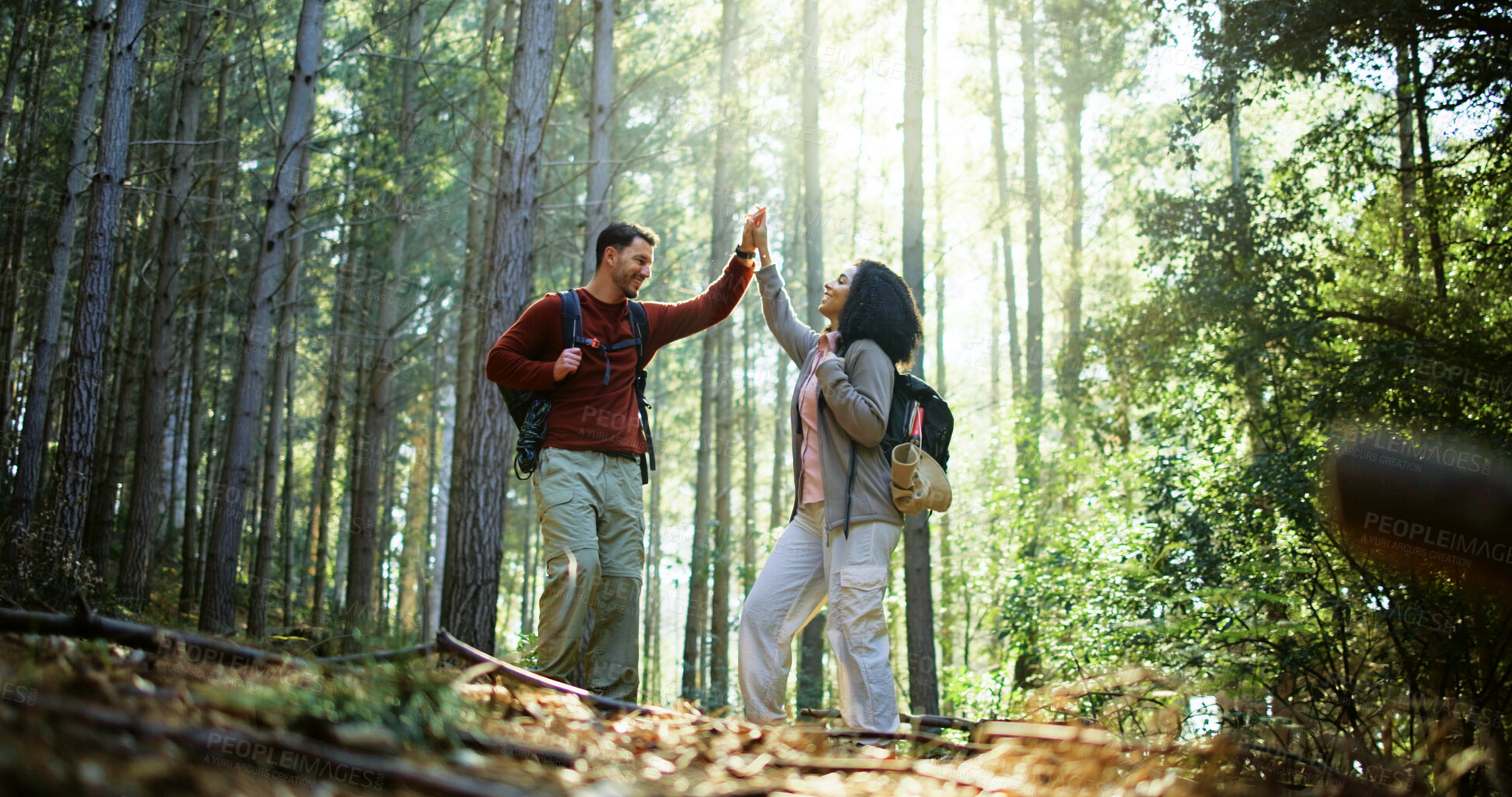 Buy stock photo Couple, high five and happy with hiking in forest with adventure, goal or achievement on travel. Man, woman and interracial relationship with celebration, love or success with backpack for trekking