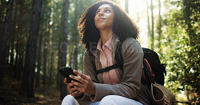 Buy stock photo Hiking break, thinking or woman with phone in forest for direction search, travel rest or map guide. Trekking, hiker and smartphone with low angle in woods for navigation, journey reflection and view