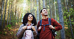 Couple, hiking and sightseeing in woods with smile, reflection or search for location with tourism. Man, woman and interracial relationship with love, happy or trekking adventure on holiday in forest
