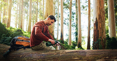 Buy stock photo Break, coffee and hiking with man in forest for hobby, trekking or thirst as tourist for journey. Adventure, beverage and travel with hiker person outdoor in nature for discovery or sightseeing