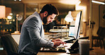 Business, night and man in workplace, computer and internet for stock market, financial agency or email. Evening, typing and person in office, pc and online reading for economy info and connection