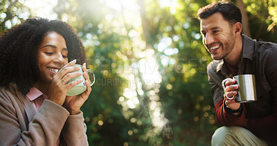 Buy stock photo Couple, hiking and coffee break in forest with smile, rest and bonding on tourism adventure in summer. Man, woman and happy with interracial love, tea cup or relax on holiday for trekking in woods