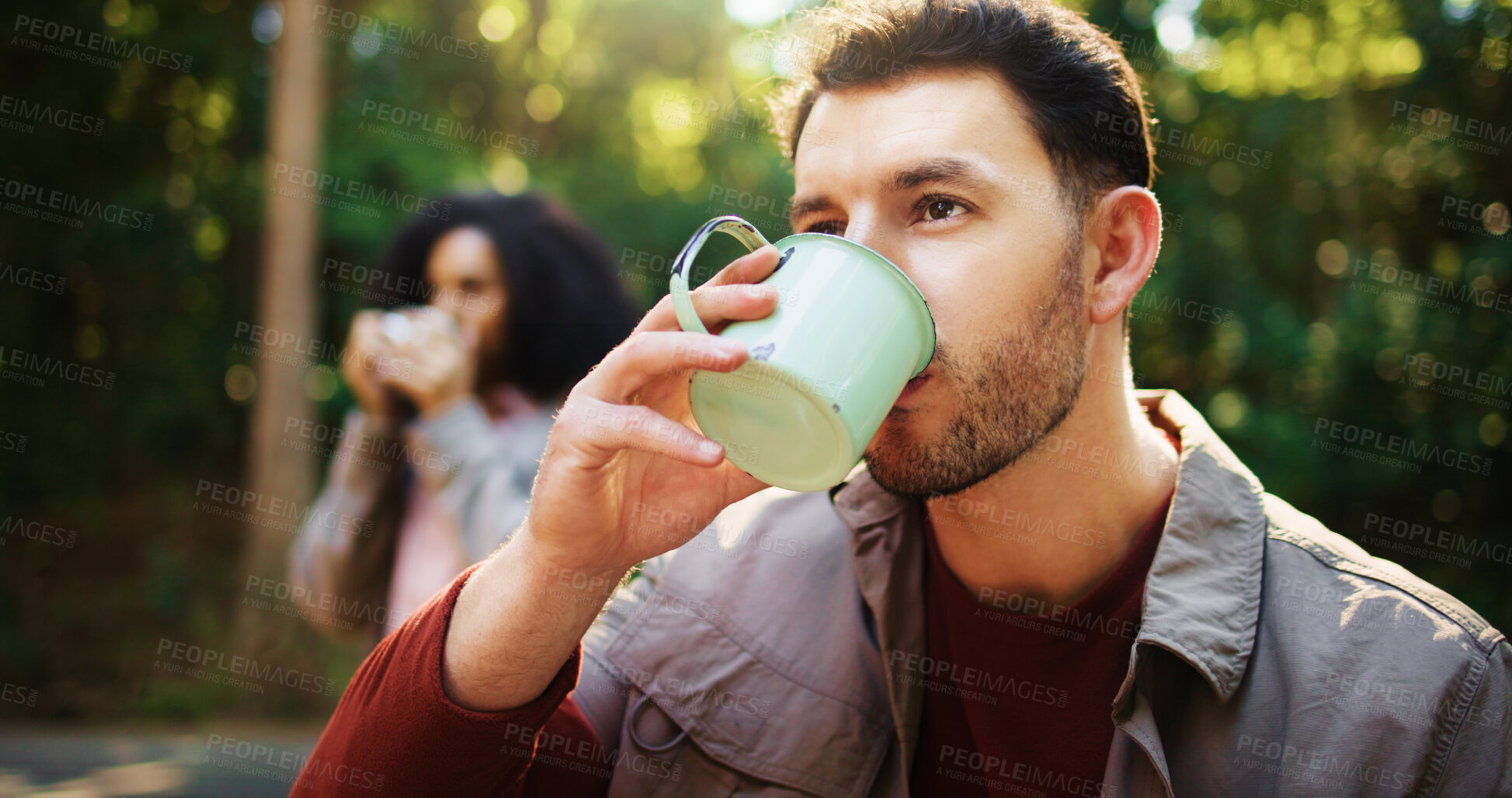 Buy stock photo Man, drinking coffee and hiking in forest with partner, rest and outdoor with reflection for nature tourism. Person, couple and memory with tea, thinking or beverage with break for trekking in woods